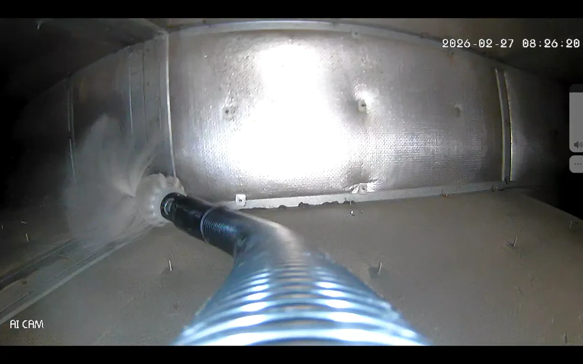 Duct inspection camera view of a cleaning hose inside commercial ductwork