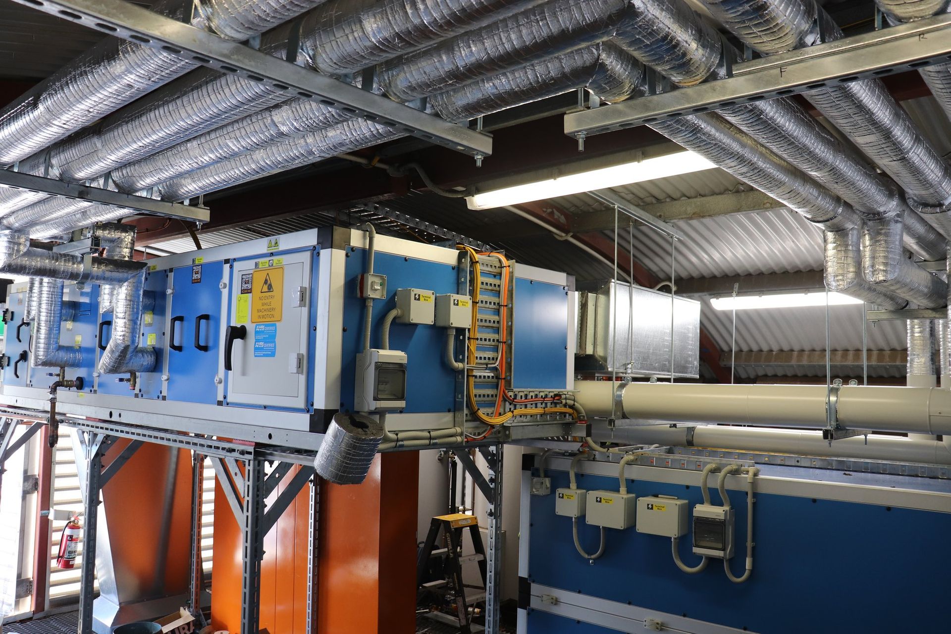Commercial plant room with air handling units and overhead ductwork installed by CSG Air